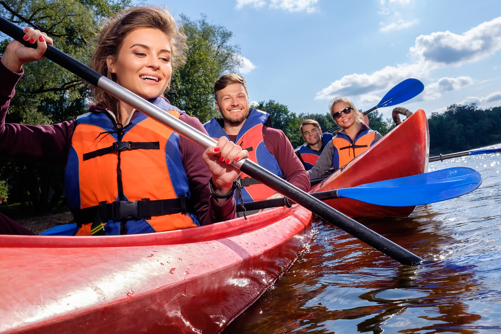 Happy best friends having fun on a kayaks